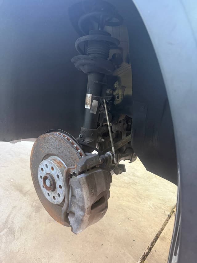 Brake caliper and rotor during an on-site brake service